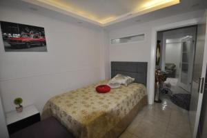 a bedroom with a bed with a red apple on it at Daire Beşiktaş 3+1 in Istanbul