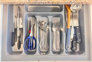 a drawer filled with utensils in a kitchen at Langkawi Seaview Cube w/ Rooftop Pool in Kuah