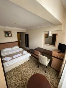 a hotel room with two beds and a desk at Hotel Topkapı in Istanbul