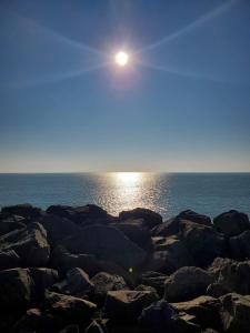 a sun rising over the ocean on a rocky beach at Les Gones en Vendée in Saint-Gervais