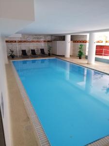 a large blue swimming pool in a building at Sonnige Ferienwohnung mit Seeblick in Uhldingen-Mühlhofen