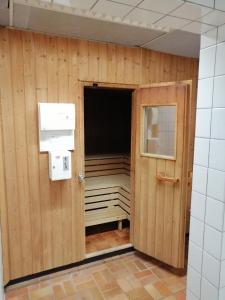 a room with a wooden wall with a door at Sonnige Ferienwohnung mit Seeblick in Uhldingen-Mühlhofen