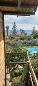 a view of a swimming pool from the porch of a house at A Due Passi Dal Mare Con Piscina in Fontane Bianche