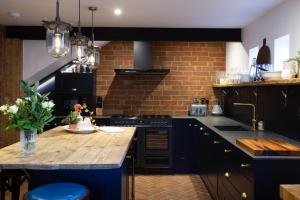 a kitchen with blue cabinets and a wooden counter top at The Workshop in York