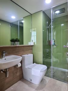 a bathroom with a toilet and a sink and a shower at Sky Suites KLCC by Asiapex in Kuala Lumpur +120 photos