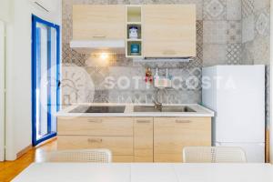 a kitchen with a sink and a refrigerator at Heavenly flat- Torre dell'Orso in Torre dell'Orso