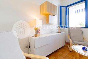 a living room with a table and a chair at Heavenly flat- Torre dell'Orso in Torre dell'Orso