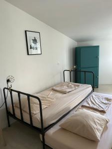 a bed in a bedroom with a green door at My Home in lourmarin in Lourmarin