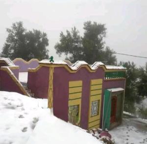 una pequeña casa de juegos para niños en la nieve en دار الضيافة تازكة Maison d'hôtes Tazekka, en Taza