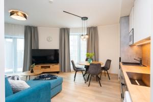 a living room with a blue couch and a table at Aatrium Kinnisvara Riia str 20A apartment, 7-th floor in Tartu