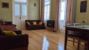 a living room with a couch and a tv at Apartment Sunrise in Sighnaghi
