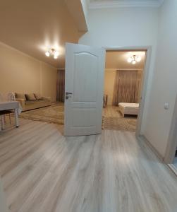 a room with a door open to a living room at Жк Metropole 2х комнатная in Almaty