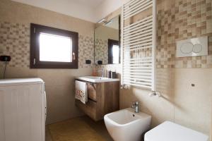 a bathroom with a sink and a toilet and a mirror at Al Vecchio Frantoio al Mare in Monopoli