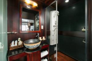 a bathroom with a sink and a mirror at La Regina Classic Cruise in Ha Long