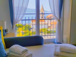 a room with a window with a view of the ocean at Bayview Studio Apartment in Tivat