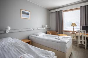a hotel room with two beds and a window at Hotel Karhu in Sodankylä +40 photos