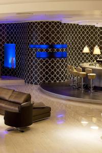 a lobby with a bar with a couch and chairs at Olympic Palace Hotel in Ixia