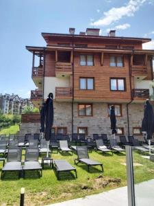 a group of chairs in front of a building at Bansko Luxury apartment in St Ivan Rilski Spa 4 Bansko Private SPA & Minreal Hot water pools in Bansko