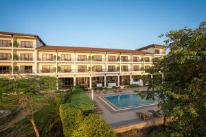 a large building with a swimming pool in front of it at Haile Resort Arbaminch in Migie