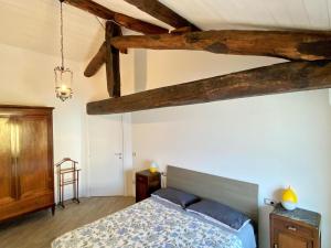 a bedroom with a bed and wooden beams at Casa Hygge Argegno – Lake Como in Argegno