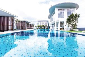 a swimming pool in front of a building at Forte Seasons Genting Windmill Upon Hills in Genting Highlands +36 photos