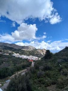 a view of a city from a hill with a blue sky at Volada view traditional apartments in Karpathos
