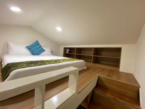 a bedroom with a large bed and wooden floors at Hualien shushu in Hualien City