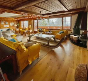 a large living room with couches and a table at Colorado Riders Chalet in Crans-Montana