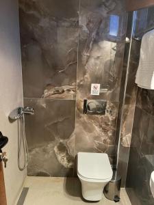 a bathroom with a toilet and a shower at Theano Studios in Paralia Sikias +100 photos
