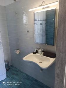 a bathroom with a sink and a mirror at GERANI apartments in Órmos