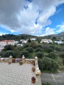 a view of a town with mountains in the background at Volada view traditional apartments in Karpathos