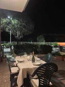 a table with a bottle of wine and glasses at Sunway Apartments 2 in Alghero
