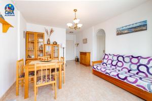 a living room with a couch and a table at Apartamentos Fontana Real Casa Azahar in Alcossebre