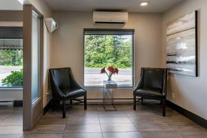 a waiting room with two chairs and a window at Dannys Hotel Suites; SureStay Collection by Best Western in Beresford