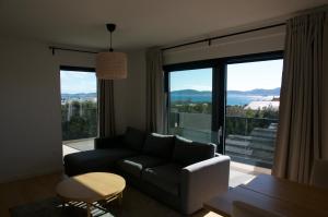 a living room with a couch and a large window at Nikola Luxury Apartments Borik in Zadar