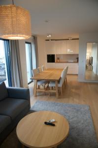a living room with a table and a dining room at Nikola Luxury Apartments Borik in Zadar