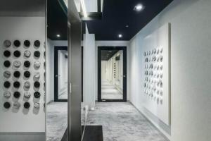 a hallway with black and white vases on the wall at Silver House by Q4Apartments in Gdynia