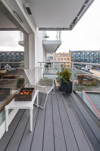 a balcony with a table and chairs on a building at Silver House by Q4Apartments in Gdynia