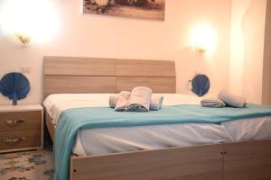 Ένα ή περισσότερα κρεβάτια σε δωμάτιο στο Vico di Mare