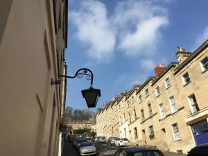 a street light on the side of a building at Quiet lower floor 2 bed city apartment with private patio garden in Bath
