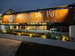 a building with a sign that reads peacock de pah at Peacock De Pai Hotel in Pai