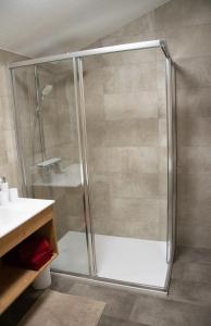 a shower with a glass door in a bathroom at Landhaus Juleiko in Nassereith