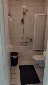 a bathroom with a shower and a toilet and a tub at Esszimmer by F.Müller in Westheim