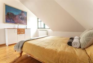 a bedroom with a bed and a painting on the wall at Casa Mila Zlatibor in Zlatibor