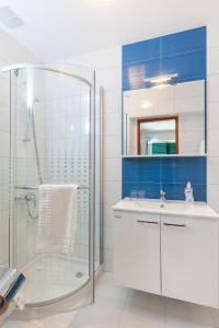 a bathroom with a shower, sink, and tub at Villa Rosa in Makarska