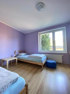 a bedroom with two beds and a window at Hostel Mamas & Papas in Gdańsk