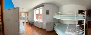 a room with two bunk beds and a window at Hostel Mamas & Papas in Gdańsk