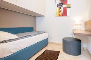a small bedroom with a bed and a table at Residence Campana in Bardolino