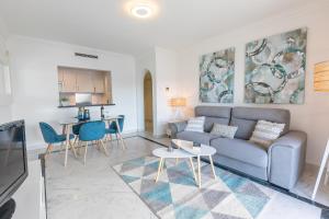 a living room with a couch and a table at VACATION MARBELLA I Marina de Banus Beach Retreat, Close to Marina and Shops in Marbella