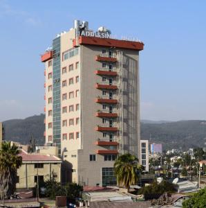 a tall building with a adidas sign on top of it at Addissinia Hotel in Addis Ababa